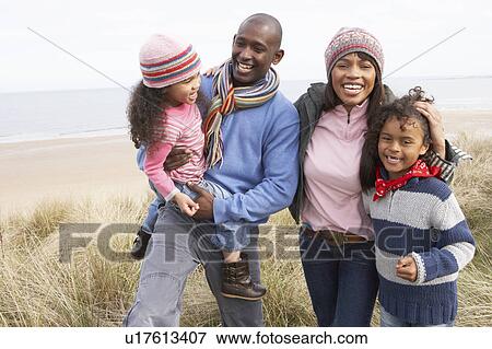Family Walking Along Dunes On Winter Beach View Large Photo Image Stock Photo - Family Walking Along Dunes On Winter Beach. Fotosearch