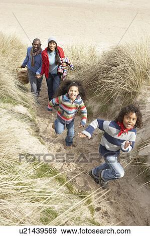 Family Walking Along Dunes On Winter Beach View Large Photo Image Stock Photo - Family Walking Along Dunes On Winter Beach. Fotosearch