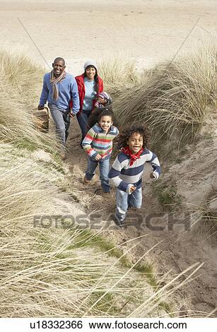 Family Walking Along Dunes On Winter Beach View Large Photo Image Stock Photograph - Family Walking Along Dunes On Winter Beach. Fotosearch
