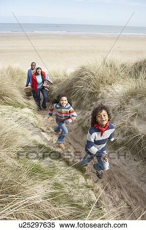 Family Walking Along Dunes On Winter Beach View Large Photo Image Stock Photography - Family Walking Along Dunes On Winter Beach. Fotosearch