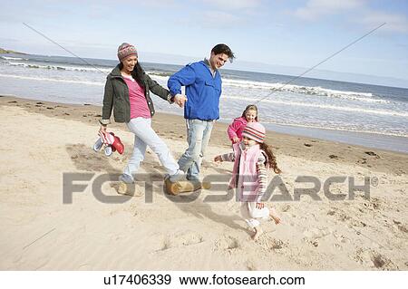 Family Walking Along Winter Beach View Large Photo Image Stock Photo - Family Walking Along Winter Beach. Fotosearch