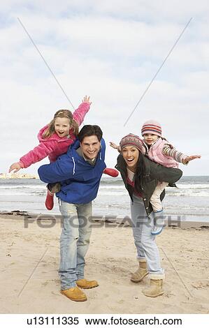 Stock Photography - Family Walking Along Winter Beach. Fotosearch