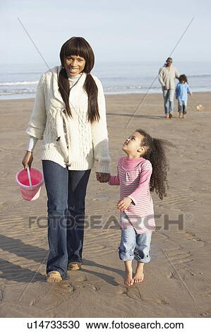 Family Walking By Sea On Winter Beach View Large Photo Image Stock Image - Family Walking By Sea On Winter Beach. Fotosearch