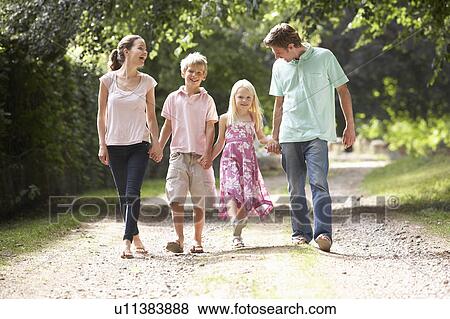 Stock Photo - Family Walking In Countryside Together. Fotosearch