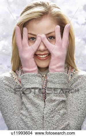 Picture - Fashionable Teenage Girl Wearing Cap And Knitwear In Studio In Front Of Christmas Tree. Fotosearch