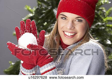 Fashionable Teenage Girl Wearing Cap And Knitwear Holding Snowball In Studio In Front Of Christmas Tree View Large Photo Image Stock Photo - Fashionable Teenage Girl Wearing Cap And Knitwear Holding Snowball In Studio In Front Of Christmas Tree. Fotosearch
