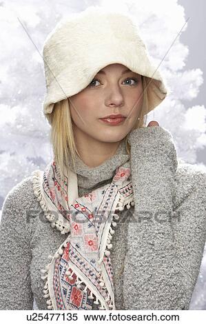 Fashionable Teenage Girl Wearing Cap And Knitwear In Studio In Front Of Christmas Tree View Large Photo Image Stock Photography - Fashionable Teenage Girl Wearing Cap And Knitwear In Studio In Front Of Christmas Tree. Fotosearch