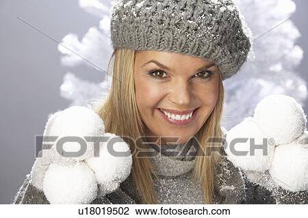 Fashionable Woman Wearing Cap And Knitwear Holding Snowball In Studio In Front Of Christmas Tree View Large Photo Image Stock Image - Fashionable Woman Wearing Cap And Knitwear Holding Snowball In Studio In Front Of Christmas Tree. Fotosearch