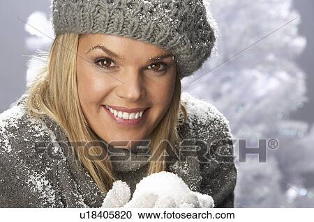 Fashionable Woman Wearing Cap And Knitwear Holding Snowball In Studio In Front Of Christmas Tree View Large Photo Image Stock Image - Fashionable Woman Wearing Cap And Knitwear Holding Snowball In Studio In Front Of Christmas Tree. Fotosearch