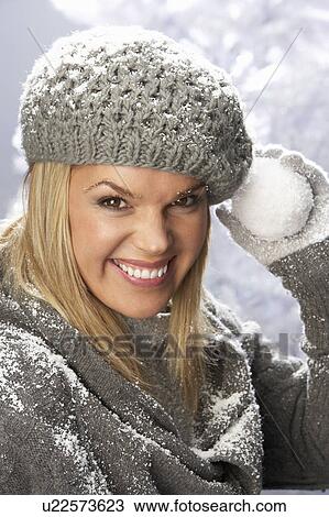 Fashionable Woman Wearing Cap And Knitwear Holding Snowball In Studio In Front Of Christmas Tree View Large Photo Image Stock Image - Fashionable Woman Wearing Cap And Knitwear Holding Snowball In Studio In Front Of Christmas Tree. Fotosearch