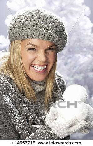 Fashionable Woman Wearing Cap And Knitwear Holding Snowball In Studio In Front Of Christmas Tree View Large Photo Image Stock Photography - Fashionable Woman Wearing Cap And Knitwear Holding Snowball In Studio In Front Of Christmas Tree. Fotosearch