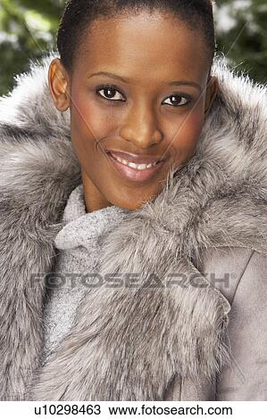 Fashionable Woman Wearing Fur Coat In Studio In Front Of Christmas Tree View Large Photo Image Stock Image - Fashionable Woman Wearing Fur Coat In Studio In Front Of Christmas Tree. Fotosearch