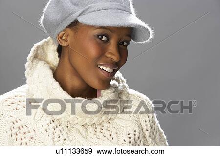 Fashionable Woman Wearing Knitwear And Cap In Studio View Large Photo Image Stock Photo - Fashionable Woman Wearing Knitwear And Cap In Studio. Fotosearch