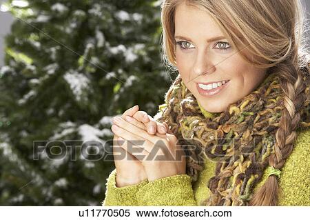 Fashionable Woman Wearing Knitwear And Scarf In Studio In Front Of Christmas Tree View Large Photo Image Stock Photography - Fashionable Woman Wearing Knitwear And Scarf In Studio In Front Of Christmas Tree. Fotosearch