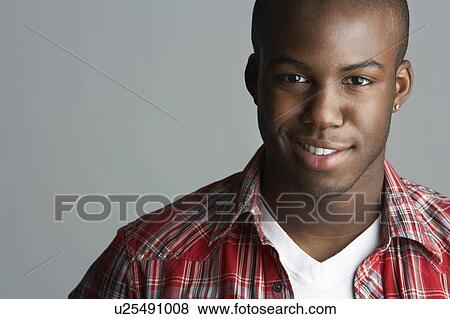 Stock Photo - Fashionable Young Man Wearing Casual Clothes In Studio. Fotosearch