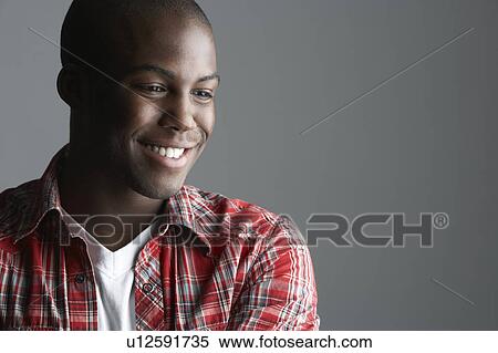 Stock Photography - Fashionable Young Man Wearing Casual Clothes In Studio. Fotosearch