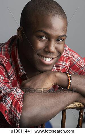 Fashionable Young Resting On Chair Man Wearing Casual Clothes In Studio View Large Photo Image Stock Image - Fashionable Young Resting On Chair Man Wearing Casual Clothes In Studio. Fotosearch