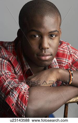 Fashionable Young Resting On Chair Man Wearing Casual Clothes In Studio View Large Photo Image Stock Photo - Fashionable Young Resting On Chair Man Wearing Casual Clothes In Studio. Fotosearch