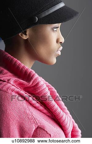 Fashionable Young Woman Wearing Cap And Knitwear In Studio View Large Photo Image Stock Photo - Fashionable Young Woman Wearing Cap And Knitwear In Studio. Fotosearch