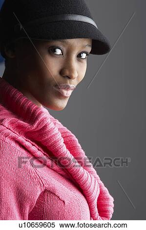 Fashionable Young Woman Wearing Cap And Knitwear In Studio View Large Photo Image Stock Photography - Fashionable Young Woman Wearing Cap And Knitwear In Studio. Fotosearch