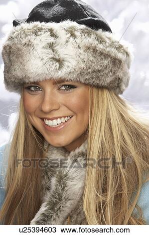 Fashionable Young Woman Wearing Fur Hat And Wrap In Studio With Artificial Christmas Tree View Large Photo Image Stock Image - Fashionable Young Woman Wearing Fur Hat And Wrap In Studio With Artificial Christmas Tree. Fotosearch