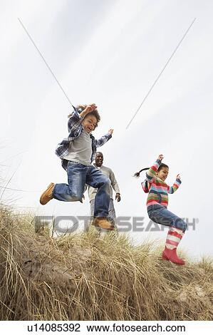 Father And Children Having Fun In Sand Dunes View Large Photo Image Stock Image - Father And Children Having Fun In Sand Dunes. Fotosearch