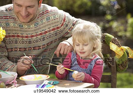Father And Daughter Decorating Easter Eggs On Table Outdoors View Large Photo Image Stock Image - Father And Daughter Decorating Easter Eggs On Table Outdoors . Fotosearch