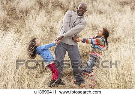 Father And Daughters Having Fun In Sand Dunes View Large Photo Image Stock Image - Father And Daughters Having Fun In Sand Dunes. Fotosearch