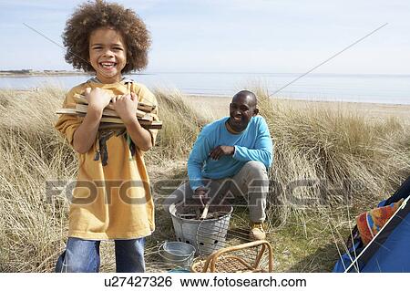 Father And Son Collecting Firewood On Beach Camping Holiday View Large Photo Image Stock Photograph - Father And Son Collecting Firewood On Beach Camping Holiday. Fotosearch