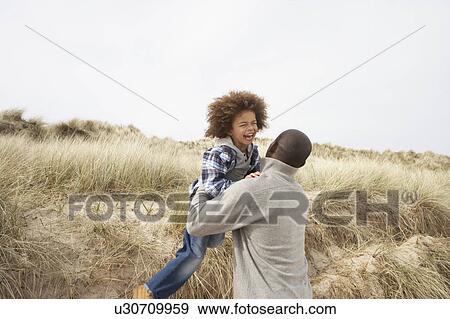 Father And Son Having Fun In Sand Dunes View Large Photo Image Stock Photo - Father And Son Having Fun In Sand Dunes. Fotosearch