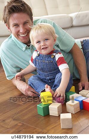 Father And Son Playing With Coloured Blocks At Home View Large Photo Image Picture - Father And Son Playing With Coloured Blocks At Home. Fotosearch