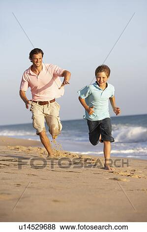 Father And Son Running Along Summer Beach View Large Photo Image Stock Photo - Father And Son Running Along Summer Beach. Fotosearch