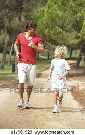Father and son running in park View Large Photo Image Stock Image - Father and son running in park. Fotosearch