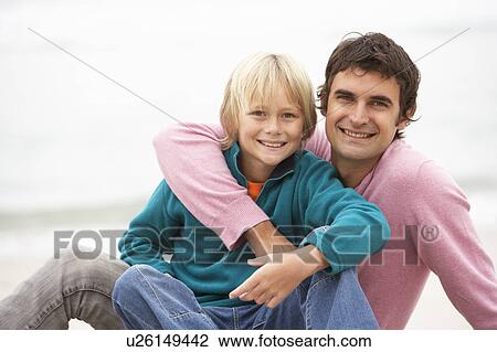 Father And Son Sitting On Winter Beach Together View Large Photo Image Stock Image - Father And Son Sitting On Winter Beach Together. Fotosearch