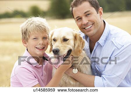 Father And Son Sitting With Dog On Straw Bales In Harvested Field View Large Photo Image Stock Photo - Father And Son Sitting With Dog On Straw Bales In Harvested Field. Fotosearch