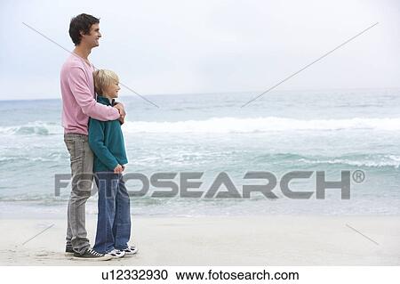 Father And Son Standing On Winter Beach Together View Large Photo Image Stock Image - Father And Son Standing On Winter Beach Together. Fotosearch