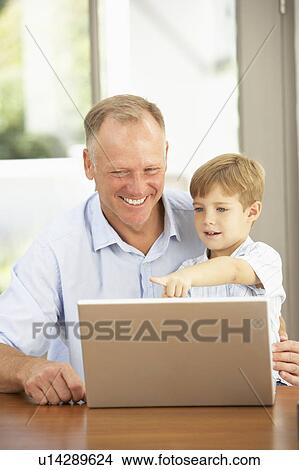 Father And Son Using Laptop At Home View Large Photo Image Picture - Father And Son Using Laptop At Home. Fotosearch