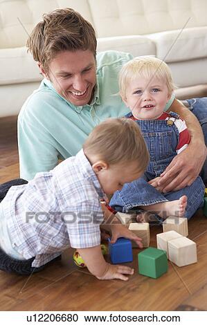 Father And Sons Playing With Coloured Blocks At Home View Large Photo Image Stock Image - Father And Sons Playing With Coloured Blocks At Home. Fotosearch