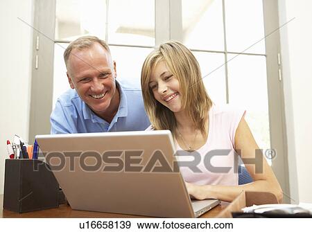 Father And Teenage Daughter Using Laptop At Home View Large Photo Image Stock Photo - Father And Teenage Daughter Using Laptop At Home. Fotosearch
