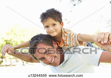 Father Giving Son Ride On Back In Park View Large Photo Image Stock Photo - Father Giving Son Ride On Back In Park. Fotosearch
