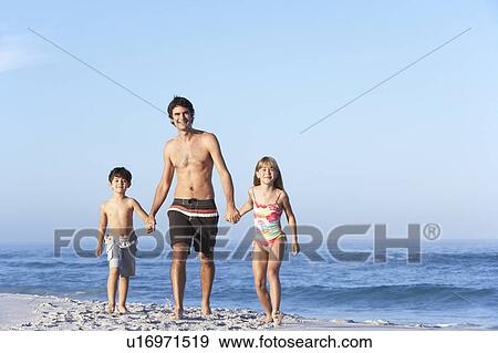 Stock Photo - Father Running With Children Along Sandy Beach. Fotosearch