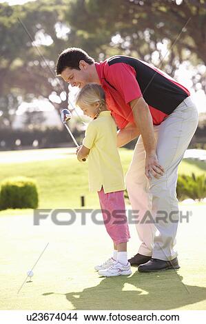 Picture - Father Teaching Daughter To Play Golf On Putting On Green. Fotosearch