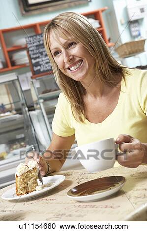 Female Customer Enjoying Slice Of Cake And Coffee In Café View Large Photo Image Stock Image - Female Customer Enjoying Slice Of Cake And Coffee In Café . Fotosearch