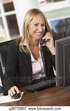 Female Estate Agent Talking On Phone At Desk View Large Photo Image Stock Photo - Female Estate Agent Talking On Phone At Desk. Fotosearch
