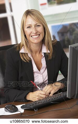 Female Estate Agent Working At Desk View Large Photo Image Stock Image - Female Estate Agent Working At Desk. Fotosearch