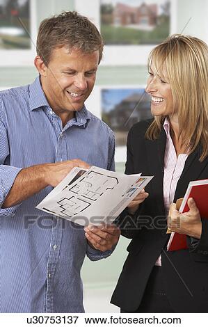 Female Estate Discussing Property Details With Client View Large Photo Image Stock Photo - Female Estate Discussing Property Details With Client. Fotosearch