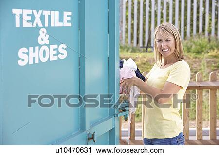 Stock Image - Female Motorist Filling Car With Diesel At Petrol Station. Fotosearch