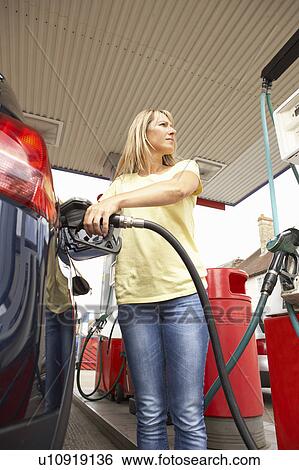 Female Motorist Filling Car With Diesel At Petrol Station View Large Photo Image Stock Photograph - Female Motorist Filling Car With Diesel At Petrol Station. Fotosearch