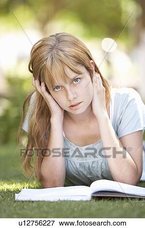 Female Teenage Student Studying In Park Looking Puzzled View Large Photo Image Stock Photo - Female Teenage Student Studying In Park Looking Puzzled. Fotosearch
