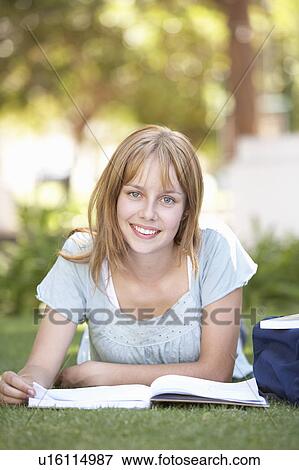 Stock Photo - Female Teenage Student Studying In Park. Fotosearch